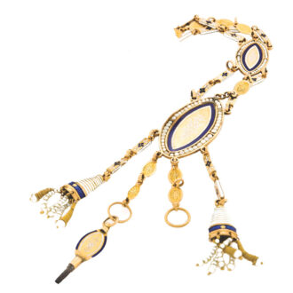 Chatelaine: three-strand links, the outer two decorated with blue and white champlevé enamel flowers, the central links with engraved gold flowerhead, two navette-shaped gold panels decorated with fine white champlevé enamel flowers, the larger panel with a standing putto in a landscape, translucent blue enamel borders and outer seed pearl borders, two pearl and gold wire tassels and a key en-suite