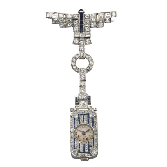 Swiss lapel watch with articulated integral diamond and ruby-set brooch Circa 1910 Swiss lapel watch with articulated integral diamond and ruby-set brooch Circa 1910