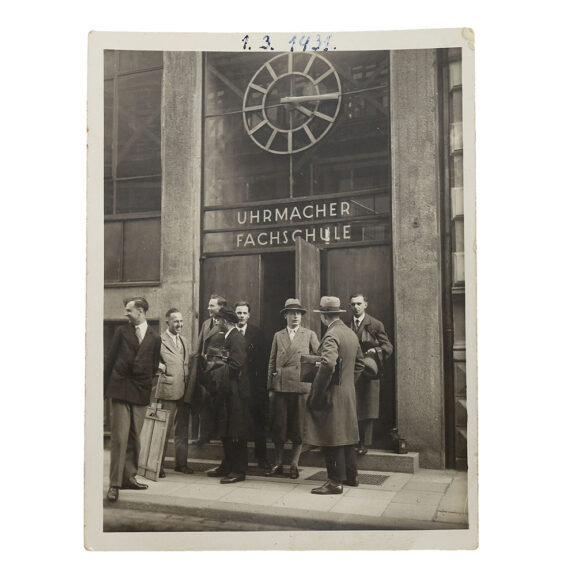 Photograph of the front of the watchmaking school with Helms and colleagues Photograph of the front of the watchmaking school with Helms and colleagues