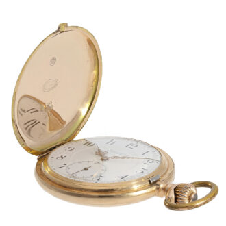 The original and well preserved white enamel dial features red gold hands