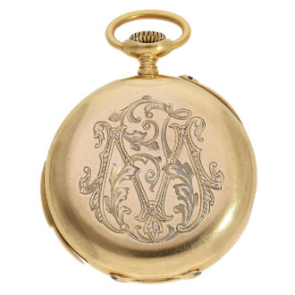 This watch has an open face case with an engraved monogram on the back This watch has an open face case with an engraved monogram on the back