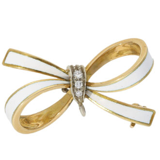 To complement this exquisite pocket watch, there is a matching gold and enamel brooch, also adorned with diamonds