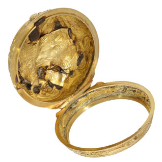 The smooth inner case is silver gold plated was probably added later