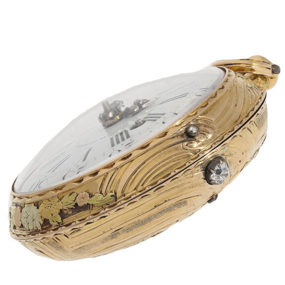 This timepiece boasts an 18 carat gold open faced glazed case adorned with a romantic relief scene on the back, worked in four gold colours and an opening button set with a large diamond This timepiece boasts an 18 carat gold open faced glazed case adorned with a romantic relief scene on the back, worked in four gold colours and an opening button set with a large diamond