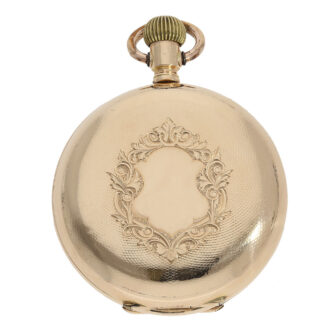 The watch is housed in a 14 carat gold case that has been glazed, engine turned and engraved