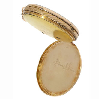 The watch’s plain open faced case is crafted from 18 Carat red gold and has a coin edge