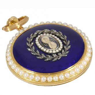 Blue guilloché enamel on the reverse, on which the glazed central part containing a lock of hair