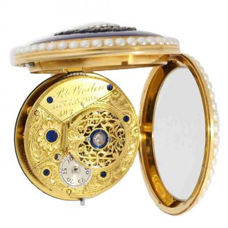 The movement is highly interesting with an exceptionally large diamond cover stone and an artistically engraved plate