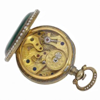 The Fleurier movement is glazed and fire gilt, has a mock pendulum and an anchor escapement