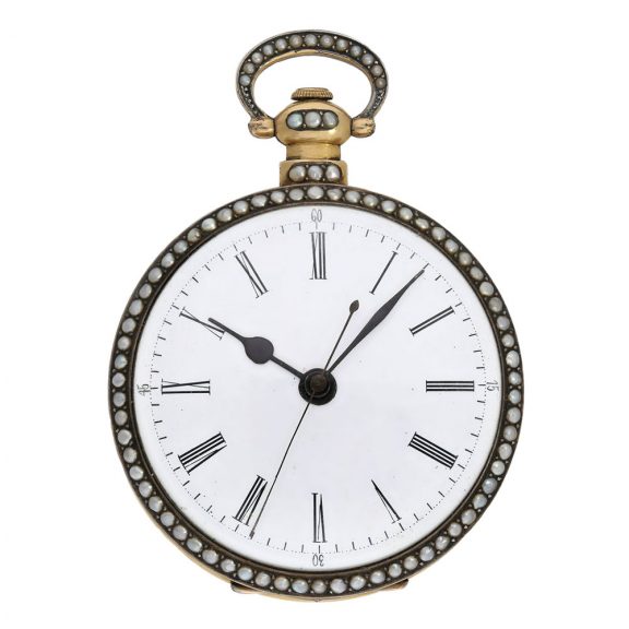 The white enamel dial has an outer ring with Arabic numerals for the minutes, an inner ring with Roman numerals for the hours, centre seconds and blued steel hands The white enamel dial has an outer ring with Arabic numerals for the minutes, an inner ring with Roman numerals for the hours, centre seconds and blued steel hands