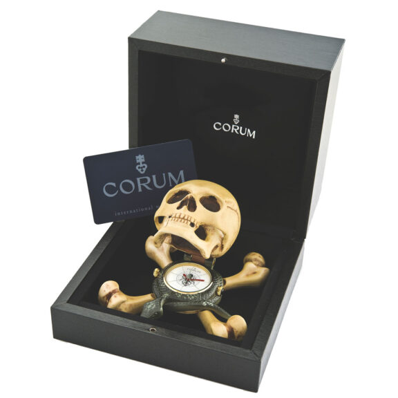 Swiss form clock in the shape of a skull atop a snake and crossbones Circa 2005Swiss form clock in the shape of a skull atop a snake and crossbones Circa 2005