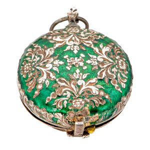 Decorative silver and enamel pill box in watch form Circa 1650