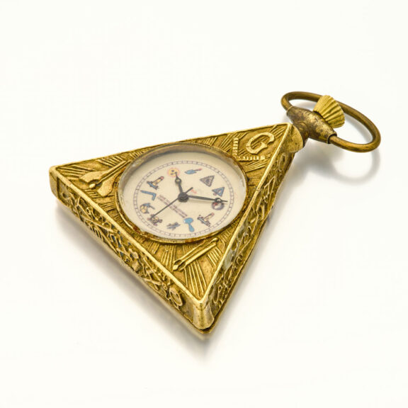 Swiss brass triangular keyless Masonic form watch Circa 1960 Swiss brass triangular keyless Masonic form watch Circa 1960