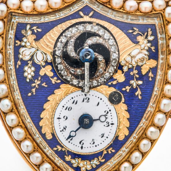Swiss gold shield shaped watch with visible balance Circa 1800 Swiss gold shield shaped watch with visible balance Circa 1800