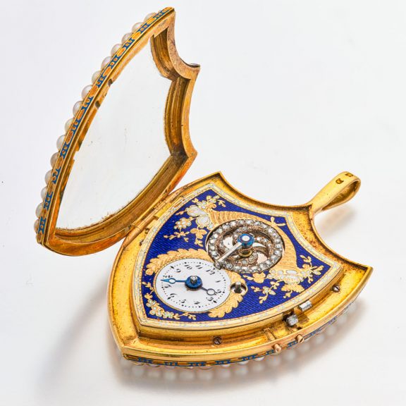 Swiss gold shield shaped watch with visible balance Circa 1800 Swiss gold shield shaped watch with visible balance Circa 1800