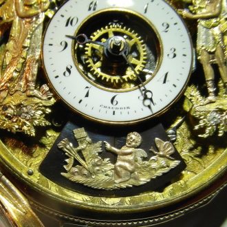 a concealed automaton at 6 o'clock has small sliding doors of blued steel decorated with a chased three-colour gold image of Cupid, the doors open whenever the repeater is activated and the erotic scene comes to life: a couple making love on a Recamier sofa