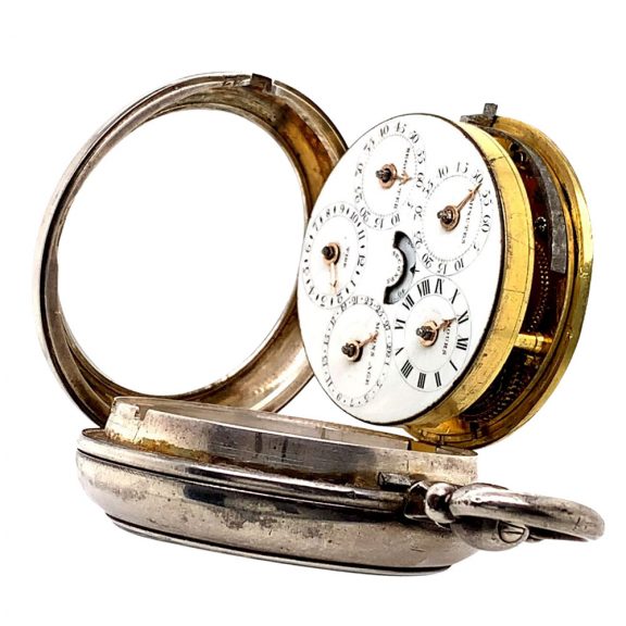 White enamel regulator dials on both sides, the one on the front features four subsidiary dials for displaying the time, the days of the week, the months and the date, the central seconds hand can be stopped with a lever on the side of the case, the back shows five subsidiary dials which display minutes, hours, moon ages, the tide and regulation, an arched aperture in the center reveals a digital retrograde second. White enamel regulator dials on both sides, the one on the front features four subsidiary dials for displaying the time, the days of the week, the months and the date, the central seconds hand can be stopped with a lever on the side of the case, the back shows five subsidiary dials which display minutes, hours, moon ages, the tide and regulation, an arched aperture in the center reveals a digital retrograde second.