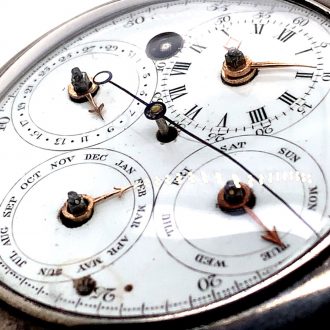 White enamel regulator dials on both sides, the one on the front features four subsidiary dials for displaying the time, the days of the week, the months and the date, the central seconds hand can be stopped with a lever on the side of the case, the back shows five subsidiary dials which display minutes, hours, moon ages, the tide and regulation, an arched aperture in the center reveals a digital retrograde second.