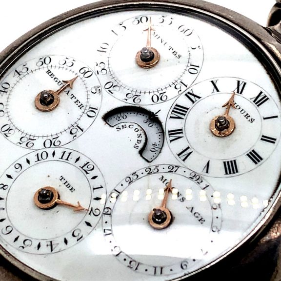 White enamel regulator dials on both sides, the one on the front features four subsidiary dials for displaying the time, the days of the week, the months and the date, the central seconds hand can be stopped with a lever on the side of the case, the back shows five subsidiary dials which display minutes, hours, moon ages, the tide and regulation, an arched aperture in the center reveals a digital retrograde second. White enamel regulator dials on both sides, the one on the front features four subsidiary dials for displaying the time, the days of the week, the months and the date, the central seconds hand can be stopped with a lever on the side of the case, the back shows five subsidiary dials which display minutes, hours, moon ages, the tide and regulation, an arched aperture in the center reveals a digital retrograde second.