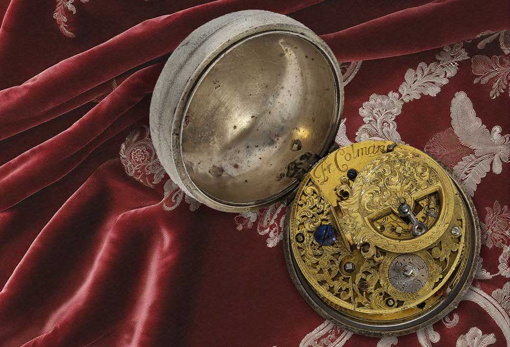 An early English pocket watch with a false pendulum.