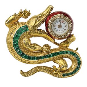 A Swiss emerald set crocodile brooch with watch Circa 1890